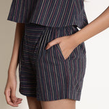 Left View of a Model wearing Navy Blue Striped Paneled Shorts