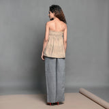 Back View of a Model wearing Convertible Beige Handwoven Cotton Shirred Top Skirt