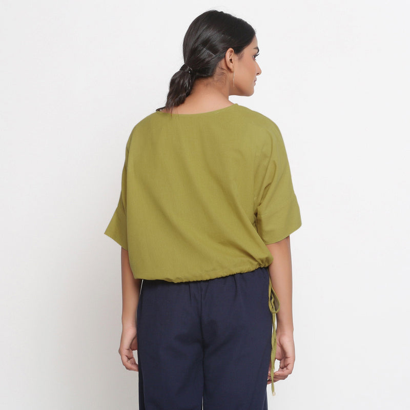 Back View of a Model wearing Solid Green Cotton Flax Blouson Top