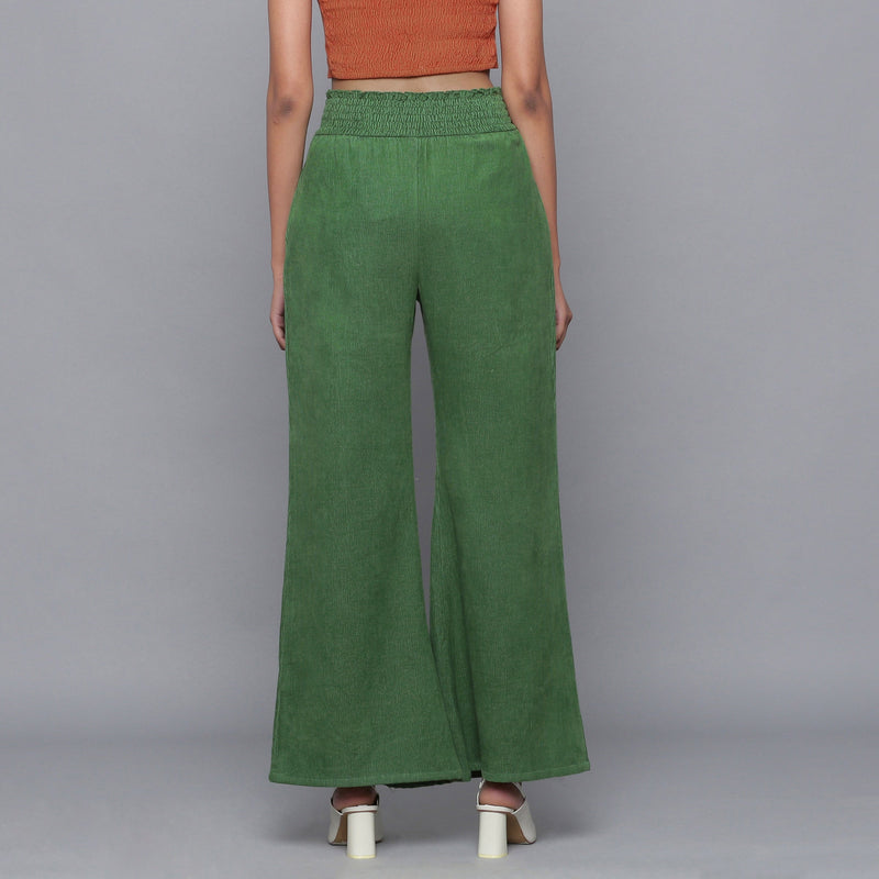 Back View of a Model wearing Green Corduroy Striped Bootcut Pant