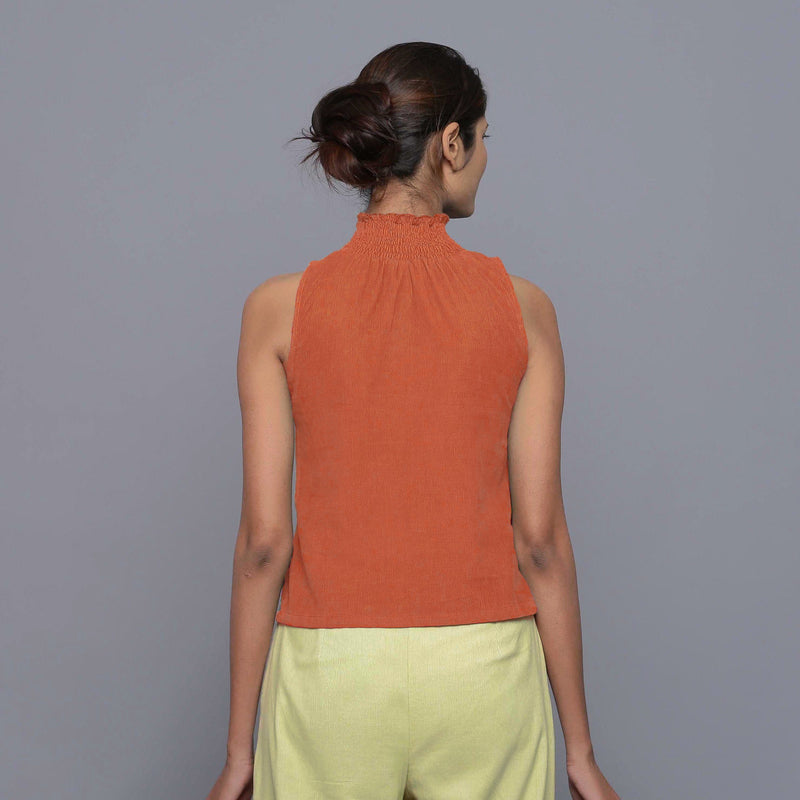Back View of a Model wearing Sunset Rust Cotton Corduroy High Neck Top