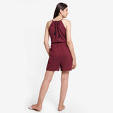 Back View of a Model wearing Crimson Polka Dot Halter Neck Romper