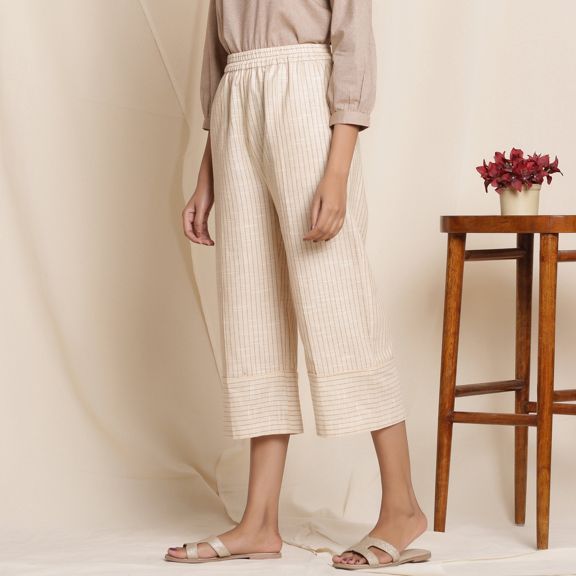 Left View of a Model wearing Dusk Beige Cotton Striped Elasticated Pant