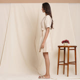 Left View of a Model wearing Dusk Beige Cotton Striped Sack Dress