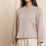Front Detail of a Model wearing Dusk Brown Straight Gathered Top