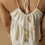 Back Detail of a Model wearing Ecru Cotton Flax Sleeveless Flared Top