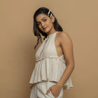 Left View of a Model wearing Ecru Cotton Flax Sleeveless Flared Top