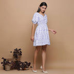 Right View of a Model wearing Powder Blue Ikat Elasticated Gathered Dress
