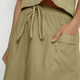 Front Detail of a Model wearing Vegetable-Dyed Green 100% Cotton Mid-Rise Skirt