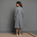 Back View of a Model wearing Grey Handspun Cotton Frilled Peasant Dress