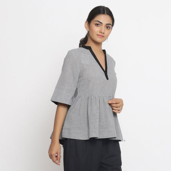 Right View of a Model wearing Solid Grey Yarn Dyed Cotton Peplum Top