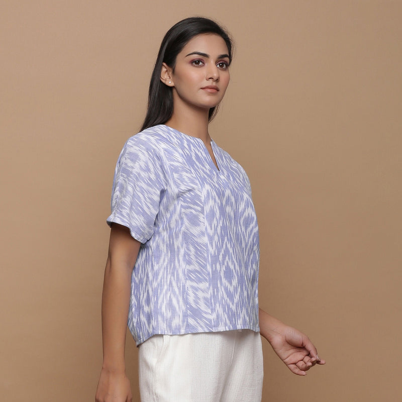 Right View of a Model wearing Ikat Powder Blue Split Neck Top