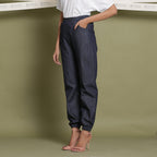 Left View of a Model wearing Indigo Cotton Denim Jogger Pant