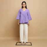 Front View of a Model wearing Lavender Asymmetrical Top and Undyed Pant Set