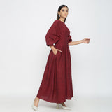 Right View of a Model wearing Maroon Solid Boat Neck Flared Dress