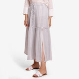 Left View of a Model wearing White Crinkled Cotton Tier Maxi Skirt