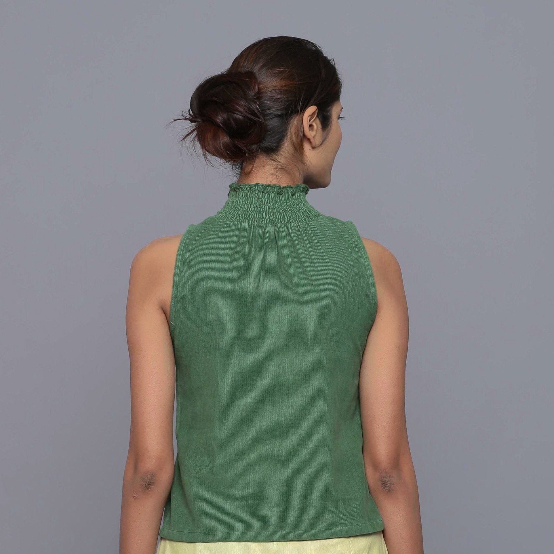 Back View of a Model wearing Green Cotton Corduroy High Neck Top