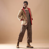 Right View of a Model wearing Muddy Green Jumpsuit and Brick Red Hoodie Set