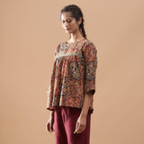 Left View of a Model wearing Muddy Red Kalamkari Flannel Floral Top