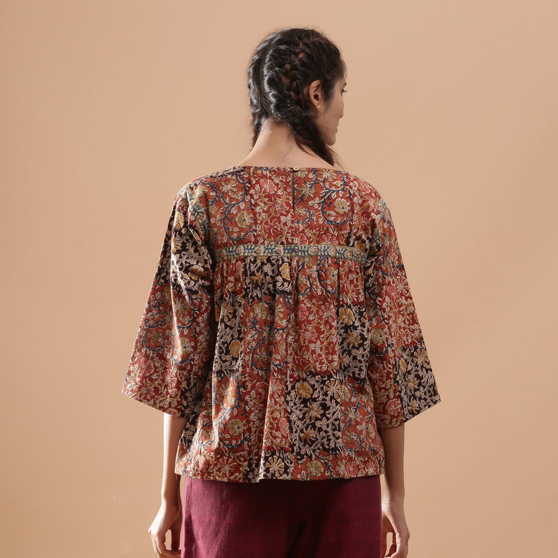 Back View of a Model wearing Muddy Red Kalamkari Flannel Floral Top