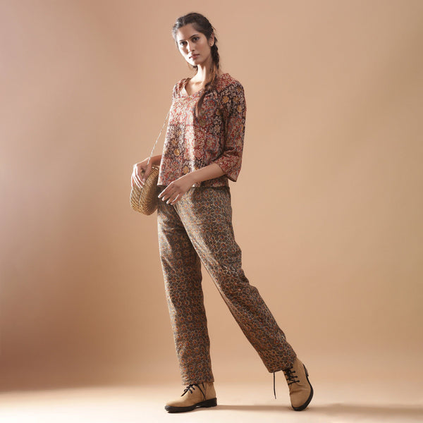 Left View of a Model wearing Muddy Red Top and Warm Muddy Green Pant Set