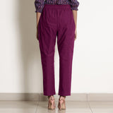 Back View of a Model wearing Warm Mulberry Frilled Waist Tapered Cotton Pant