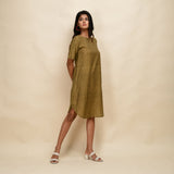 Right View of a Model wearing Mustard Gold 100% Cotton Khadi Knee Length Dress