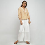 Front View of a Model wearing Mustard Hand Block Printed Straight Top