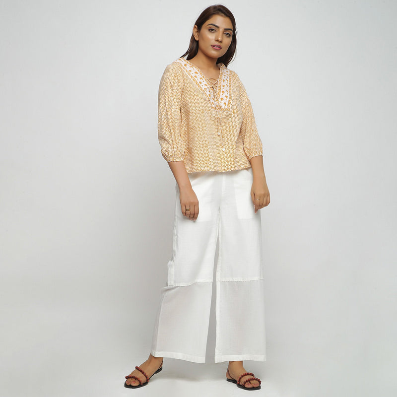 Front View of a Model wearing Mustard Hand Block Printed Straight Top