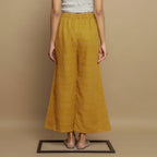 Back View of a Model wearing Mustard Paneled Striped Handwoven Pant