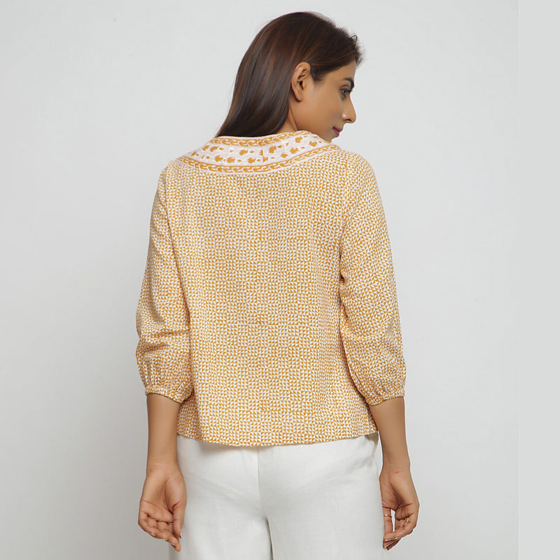 Back View of a Model wearing Mustard Hand Block Printed Straight Top