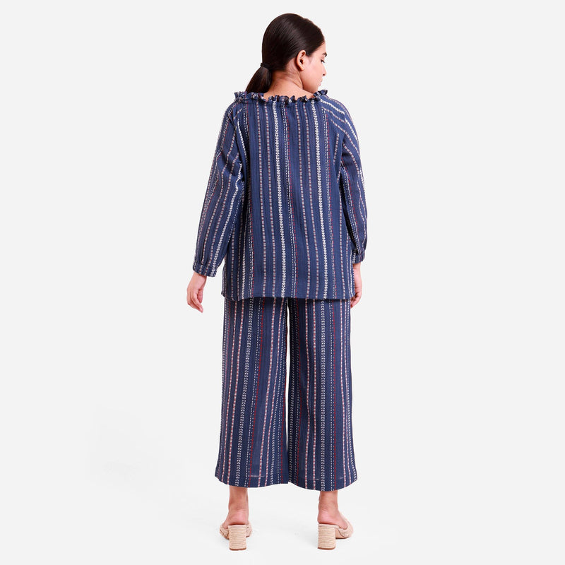 Back View of a Model wearing Navy Blue Off-Shoulder Top and Striped Culottes