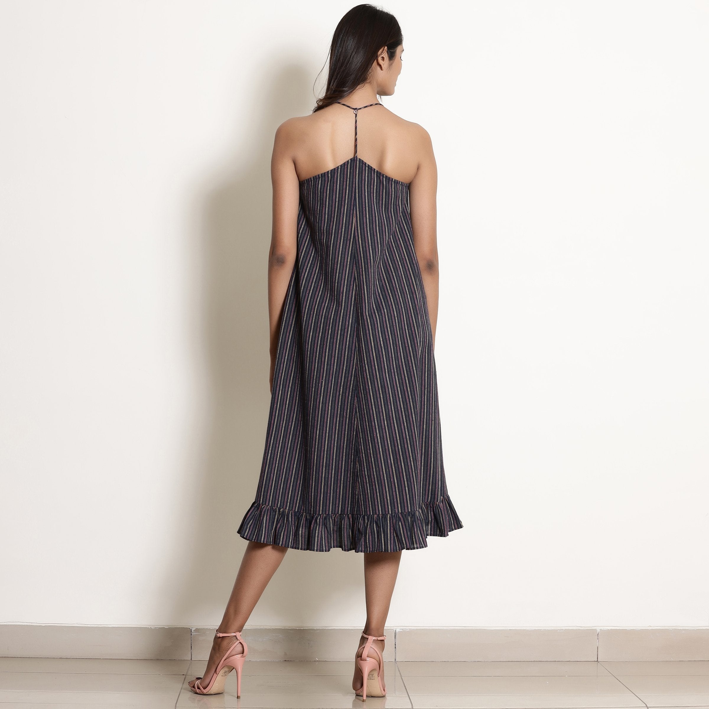Back View of a Model wearing Navy Blue Striped Halter Neck Frilled Dress