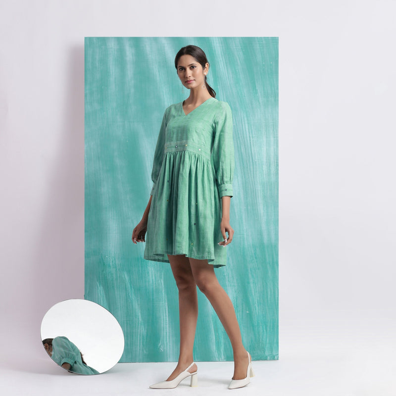 Left View of a Model wearing Ocean Green Handspun 100% Cotton Gathered Dress