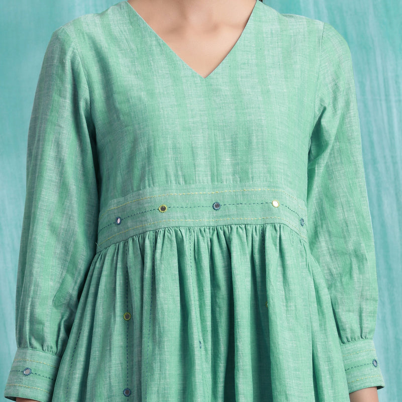 Front Detail of a Model wearing Ocean Green Handspun 100% Cotton Gathered Dress