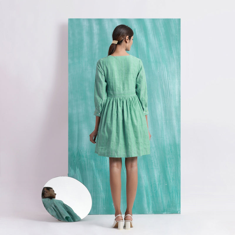 Back View of a Model wearing Ocean Green Handspun 100% Cotton Gathered Dress