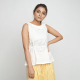 Front View of a Model wearing Ruffled Off-White Cotton Peplum Top