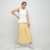 Front View of a Model wearing Off-White Peplum Top and Wide Legged Pant Set