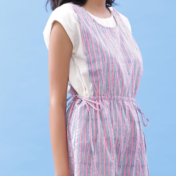 Front Detail of a Model wearing Off-White Top and Striped Jumpsuit Set