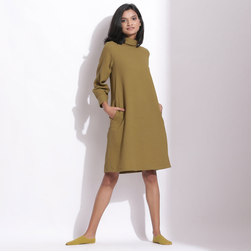 Front View of a Model wearing Olive Green Cotton Waffle Turtle Neck Dress