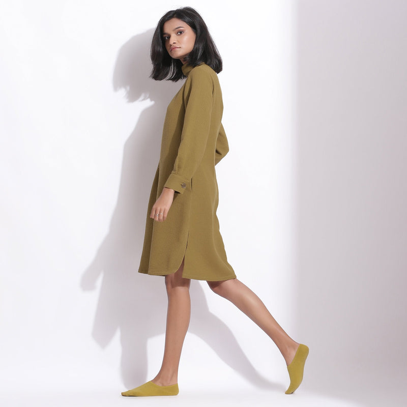 Left View of a Model wearing Olive Green Cotton Waffle Turtle Neck Dress