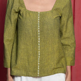 Front Detail of a Model wearing Olive Green Handspun Cotton Beaded Top