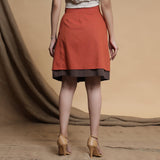 Back View of a Model wearing Orange and Brown Reversible Pleated Flared Skirt