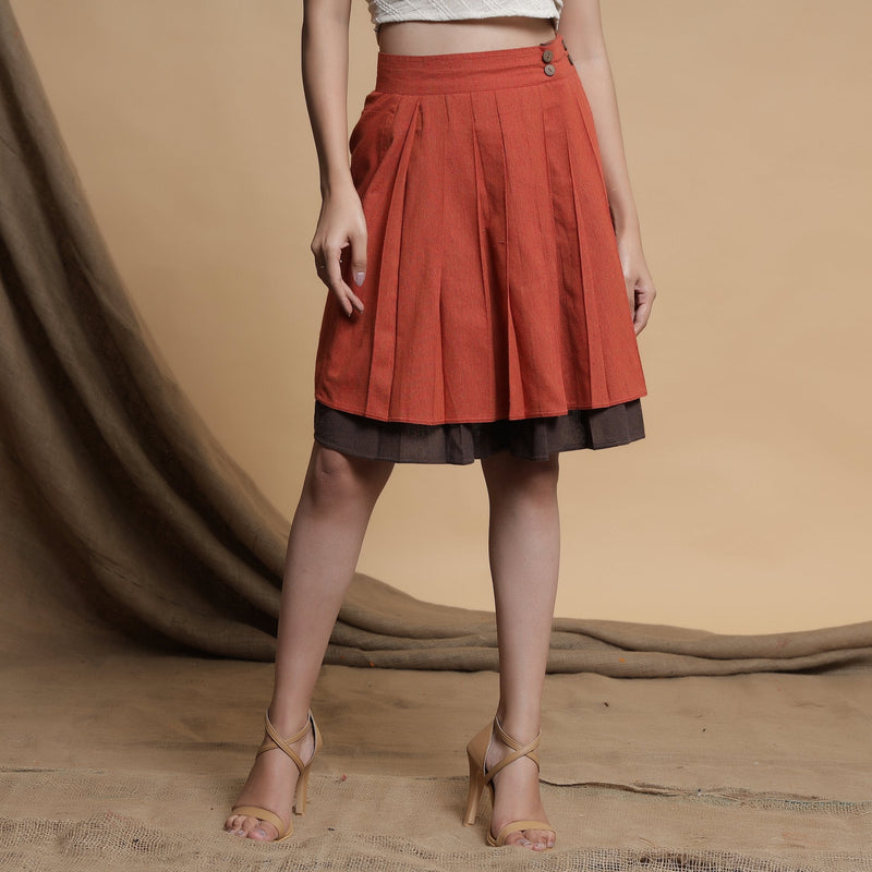 Front View of a Model wearing Orange and Brown Reversible Pleated Flared Skirt