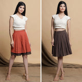 Front View of a Model wearing Orange and Brown Reversible Pleated Flared Skirt