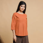 Front View of a Model wearing Orange Box-Pleated High Low Top