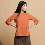 Front View of a Model wearing Orange Box-Pleated High Low Top