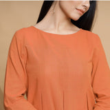 Front Detail of a Model wearing Orange Box-Pleated High Low Top