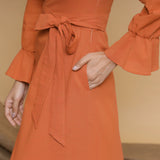 Front Detail of a Model wearing Orange Floor Length Pleated Tier Dress