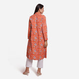 Back View of a Model wearing Orange Floral Knee Length Trench Coat